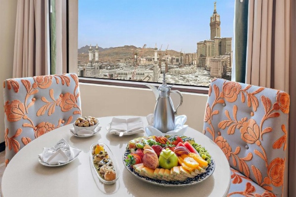 In-room dining at Anjum Makkah with city backdrop